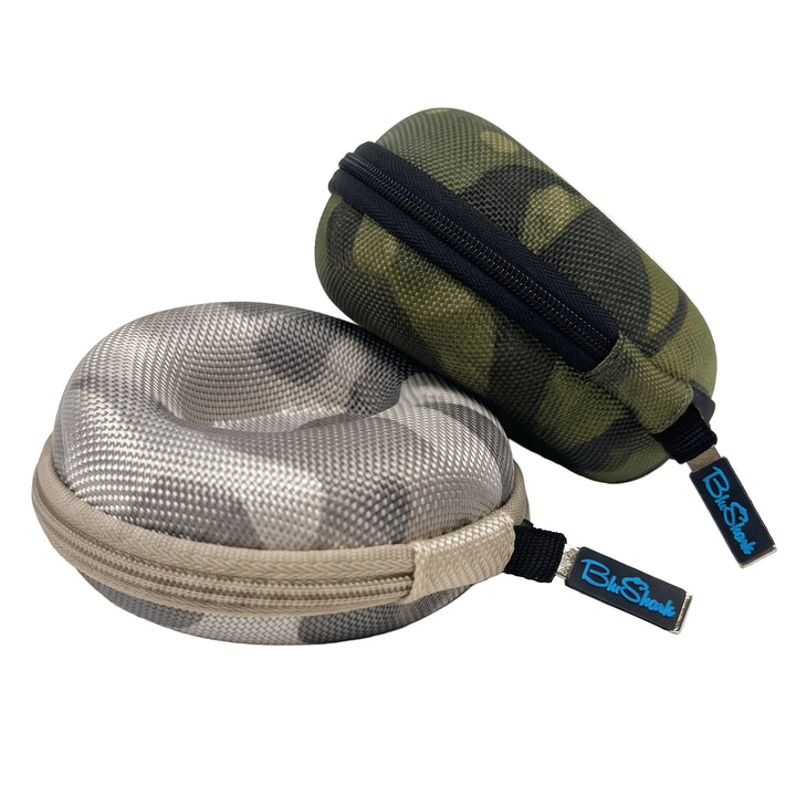 Two hard mesh zippered eyeglasses cases on a white background, one in gray and beige camouflage and the other in green and black camouflage, both with black zipper pulls labeled ExShock.