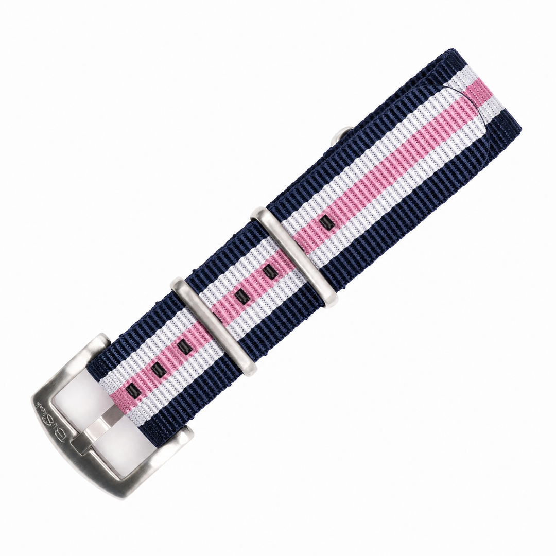 A nylon watch strap with a navy blue, white, and pink stripe pattern, featuring silver-toned metal hardware and a silver buckle.